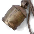 Rustic metal bell with a rope on a white background