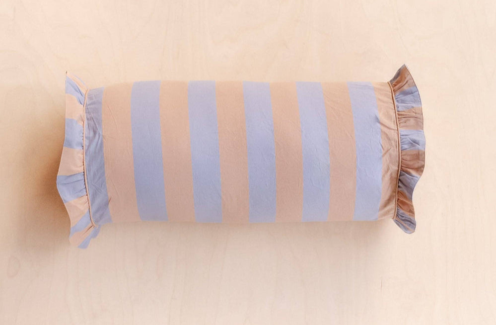 Bolster pillow with striped pattern on a beige background