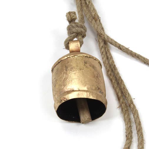 Brass bell with a rope on a white background