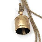Brass bell with a rope on a white background